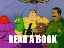 still image of animated Tick cartoon where a hand puppet yells READ A BOOK