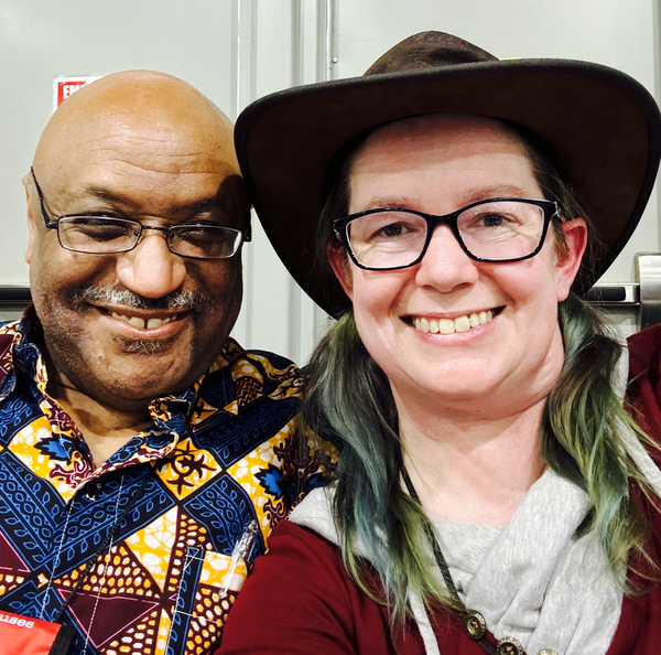 Photo of Maurice Broaddus and me at the World Fantasy Con mass signing on Friday night. Note the hat and the hair, which looks purposefully different shades of green instead of very old blue that has faded because I haven't freshened the color in forever.